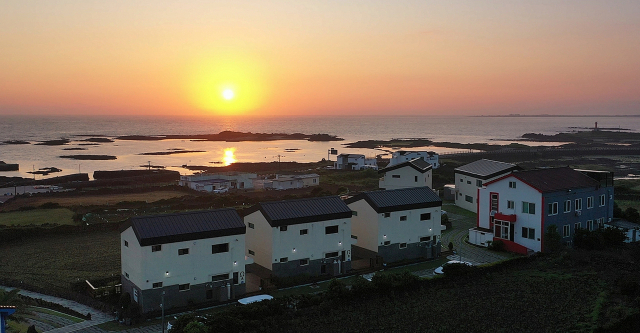 제주도 구름밭하우스 너머로 아침 해가 떠오르고 있다.구름밭하우스 창을 열면 문주란 자생지인 토끼섬과 아침햇살이 하루를 반긴다.이채근 기자 mincho@imaeil.com
