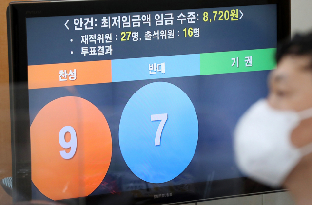 14일 새벽 세종시 정부세종청사 고용노동부에서 열린 제9차 최저임금위원회 전원회의 결과 브리핑을 취재진이 경청하고 있다. 이날 전원회의는 근로자위원들의 집단 퇴장으로 공익위원들이 낸 안으로 표결에 부쳐졌다. 찬성 9표, 반대 7표로 채택된 내년도 최저임금은 시급 기준 8천720원으로 최종 의결됐다. 연합뉴스