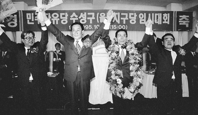 1995년 10월 21일 열린 민자당 대구 수성을 지구당 임시대회. 윤영탁(오른쪽에서 두 번째) 의원이 선출되자 김윤환(왼쪽에서 두 번째) 대표가 손을 들어 환호하고 있다. 매일신문 DB