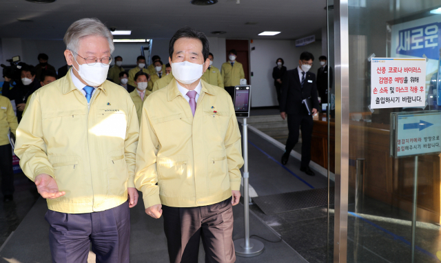 정세균 국무총리(오른쪽)와 이재명 경기도지사가 9일 경기도 수원시 경기도청에서 열린 코로나19 중대본 회의를 마친 뒤 청사 밖으로 함께 이동하고 있다. 연합뉴스