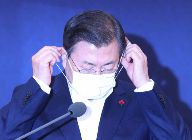 문재인 대통령이 지난 21일 오후 청와대에서 열린 제3차 국가과학기술자문회의 전원회의에서 발언을 위해 마스크를 벗고 있다. 연합뉴스