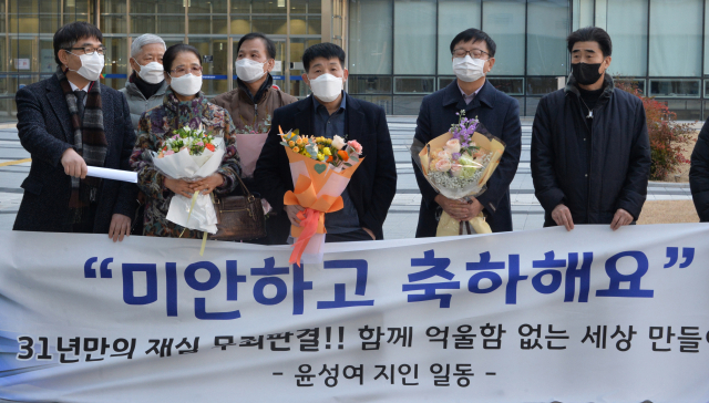 17일 오후 경기도 수원시 영통구 수원지방법원에서 열린 이춘재 연쇄살인 8차 사건 재심 선고공판에서 재심 청구인 윤성여 씨가 무죄를 선고받고 법원 청사를 나와 지인들의 축하를 받고 있다. 연합뉴스