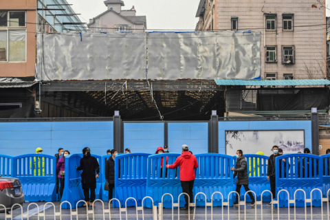 지난달 31일 세계보건기구(WHO) 전문가팀이 우한(武漢) 수산시장을 방문하기에 앞서 인부들이 장벽을 설치하고 있다. AFP·연합뉴스