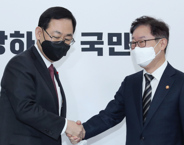 국민의힘 주호영 원내대표(왼쪽)가 8일 국회에서 예방한 박범계 법무부 장관과 악수하고 있다. 연합뉴스