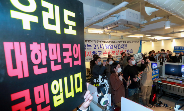 8일 자정 서울 강서구의 한 피시방에서 코로나19 대응 전국자영업자 비상대책위 주최로 열린 방역기준 불복 개점 시위에서 참석자들이 정상 영업을 촉구하며 구호를 외치고 있다. 연합뉴스