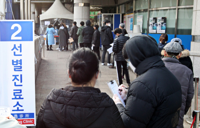 설날인 12일 오전 서울시 동작구 보건소 코로나19 선별진료소를 찾은 시민들이 검사를 받기 위해 줄을 서 있다. 연합뉴스