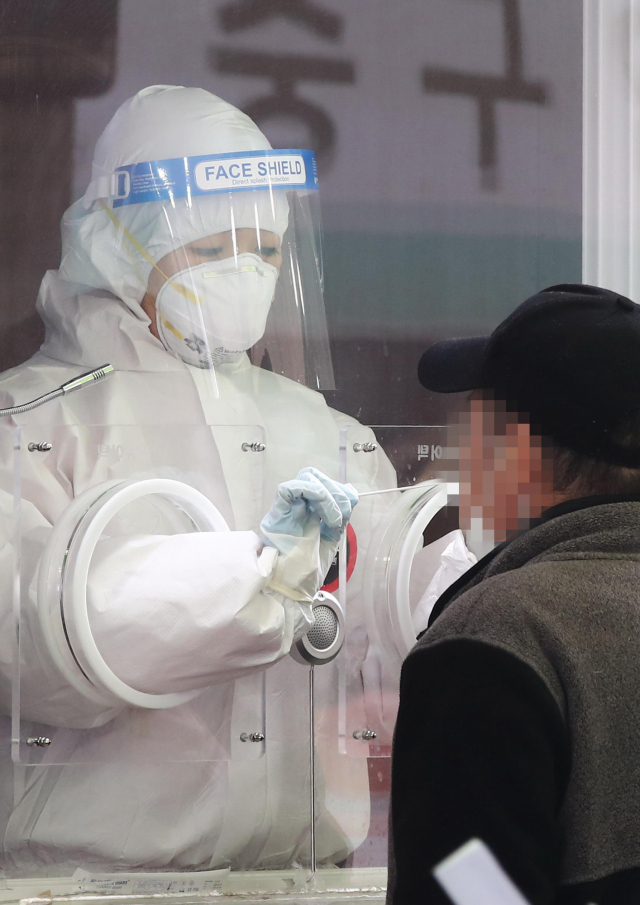15일 오후 서울역에 마련된 코로나19 임시 선별검사소에서 의료진이 검체를 채취하고 있다. 중앙방역대책본부는 이날 0시 기준으로 국내 코로나19 신규 확진자가 344명 늘어 누적 8만3천869명이라고 밝혔다. 연합뉴스