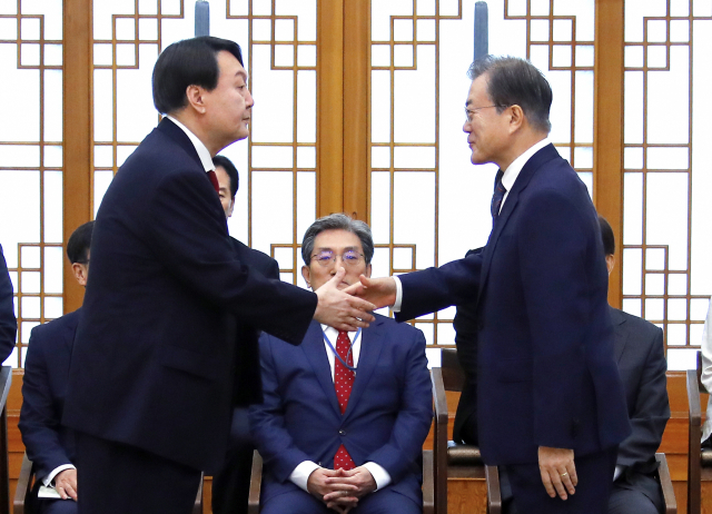 문재인 대통령이 2019년 7월 25일 청와대에서 윤석열 당시 신임 검찰총장에게 임명장을 수여한 뒤 악수하는 모습. 연합뉴스DB