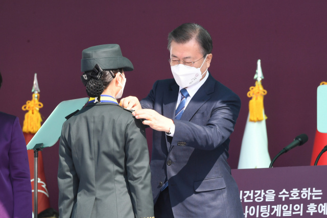 문재인 대통령이 5일 대전광역시 국군간호사관학교에서 열린 제61기 졸업 및 임관식에서 졸업생도에게 계급장을 수여하고 있다. 연합뉴스