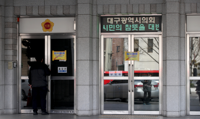 대구시의회 의원이 코로나19 확진 판정을 받은 18일 오전 대구 중구 대구시의회 청사가 입구에 폐쇄 안내문이 붙어 있다. 김영진 기자 kyjmaeil@imaeil.com