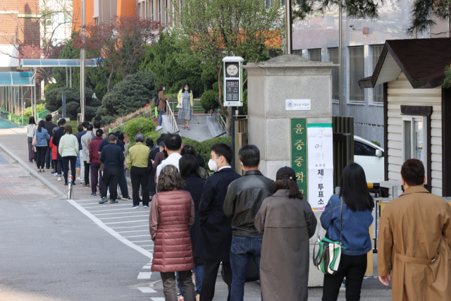 서울시장 보궐선거일인 7일 오전 여의도 한 투표소에서 시민들이 투표하기 위해 줄을 서서 기다리고 있다. 연합뉴스
