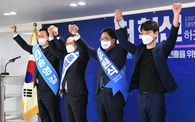 더불어민주당 송영길(왼쪽부터), 홍영표, 우원식, 정한도 당대표 후보가 18일 오전 서울 여의도 중앙당사에서 열린 더불어민주당 당대표 후보자 선출을 위한 예비경선대회에서 손을 맞잡아 들고 인사하고 있다. 연합뉴스