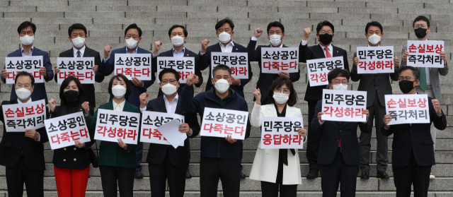 국민의힘 초선의원들과 원내대표 후보들이 29일 서울 여의도 국회 본청 앞에서 열린 손실보상법 무산 규탄 및 처리 촉구 결의대회에서 구호를 외치고 있다. 연합뉴스