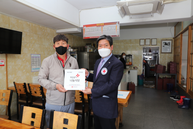 주오호 영주 꼬꼬반점 대표가 희망풍차 나눔 명패를 전달 받고 있다. 마경대 기자