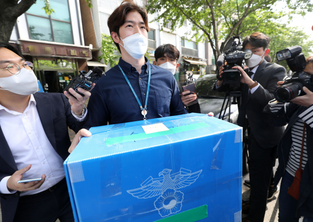 서울경찰청 안보수사과 관계자들이 6일 오후 지난달 비무장지대(DMZ) 인근에서 두 차례에 걸쳐 대북전단을 살포했다고 밝힌 박상학 자유북한운동연합 대표의 사무실에 대한 압수수색을 마친 뒤 압수품을 들고 나오고 있다. 연합뉴스