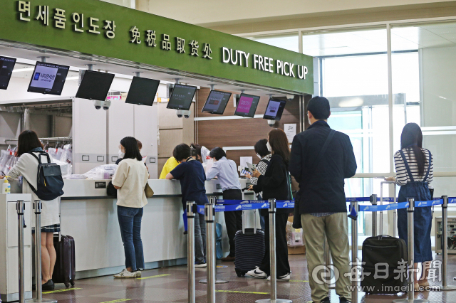 대구공항에서 무착륙 국제관광비행이 운행되는 가운데 대구공항 면세품 인도장이 탑승객들로 붐비고 있다. 매일신문DB
