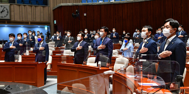 더불어민주당 송영길 대표, 윤호중 원내대표 등이 지난 18일 서울 여의도 국회에서 열린 부동산 세제 관련 정책의원총회에서 국민의례를 하고 있다. 연합뉴스