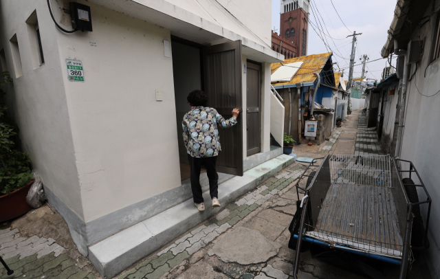 23일 오후 대구 북구 칠성시장에 위치한 피란민촌에서 한 주민이 골목에 위치한 마을 공용화장실로 들어가고 있다. 김영진 기자 kyjmaeil@imaeil.com