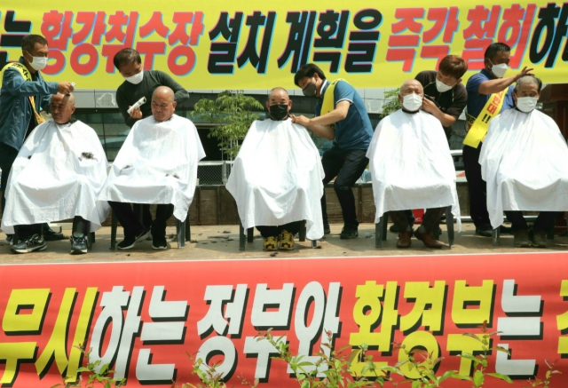 세종시 정부청사 환경부 정문 앞에서 배몽희 합천군의회 의장, 황강취수장 설치반대 군민대책위원회 이종철 공동위원장, 마홍렬 감사, 송정호 위원, 권재영 위원 등 5명이 삭발을 하고 있다.