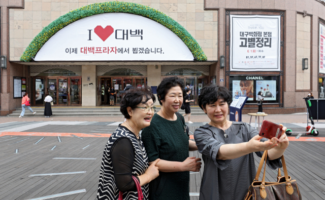 전국 유일 향토백화점인 대구백화점 본점이 30일 영업을 마지막으로 7월 1일부터 잠정 휴업에 들어간다. 이날 오전 대구 중구 대구백화점 본점 앞에서 시민들이 추억을 남기기 위해 사진을 찍고 있다. 김영진 기자 kyjmaeil@imaeil.com