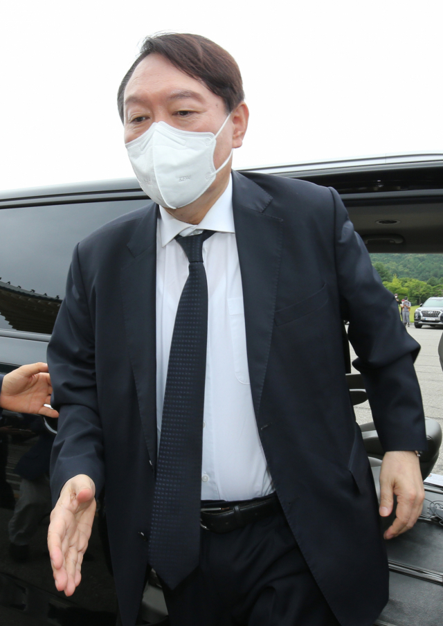 윤석열 전 검찰총장이 6일 오전 대전 유성구 국립대전현충원에서 도착해 참배에 앞서 지지자들과 인사하기 위해 손을 내밀고 있다. 연합뉴스