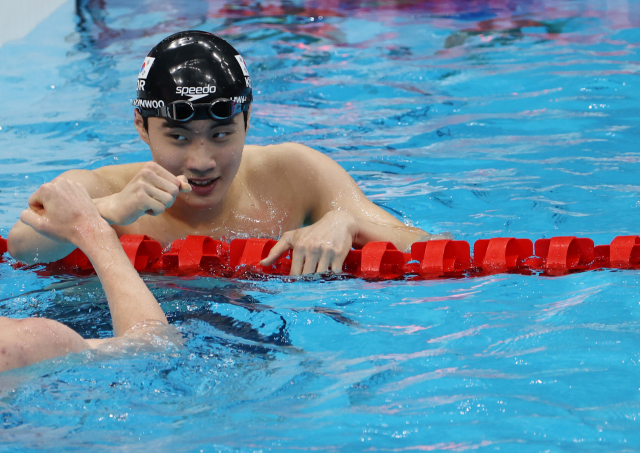 25일 일본 도쿄 아쿠아틱스 센터에서 열린 남자 자유형 200m 예선에 출전한 한국 황선우가 경기를 마친 뒤 영국 톰 딘의 축하를 받고 있다. 황선우는 1분44초62를 기록해 한국신기록을 세웠다. 연합뉴스