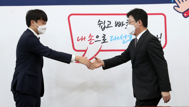 국민의힘 이준석 대표(왼쪽)가 17일 서울 여의도 국회에서 유승민 대선 경선 예비후보와 악수하고 있다. 연합뉴스