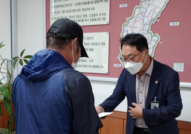 정용환 장마면장이 익명의 기부자로부터 받은 성금 100만원을 소외계층에 전달하고 있다. 장마면 제공