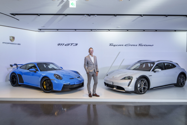 포르쉐코리아가 14일 '타이칸 크로스 투리스모'(오른쪽)와 신형 '911 GT3'의 국내 출시 기념 특별 전시회를 했다. 사진은 기념 촬영하는 홀가 게어만 대표. 연합뉴스