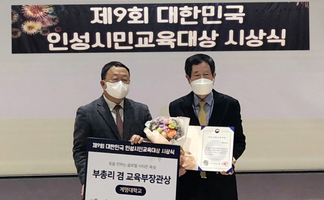 이중희(오른쪽)계명인성교육원장과 이상수 교육부 학교혁신지원실장이 시상 후 기념사진을 찍고 있다. 계명대 제공