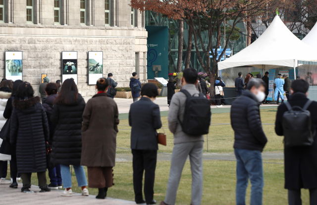 9일 서울시청 앞에 마련된 서울광장 신종 코로나바이러스 감염증(코로나19) 선별진료소에서 검사를 받으려는 시민들이 줄을 서고 있다. 연합뉴스