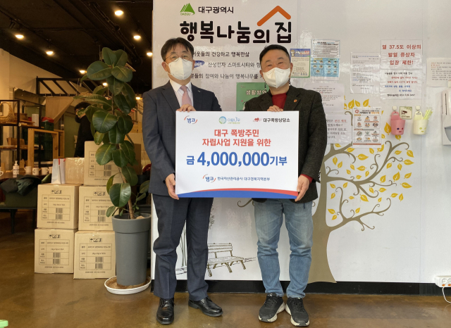 한국자산관리공사(캠코) 박상원 대구경북지역본부장(왼쪽)이 대구쪽방상담소 장민철 소장(오른쪽)에게 중구 행복나눔의 집에서 기부금을 전달하고 함께 기념 촬영을 하고 있다. 한국자산관리공사 제공