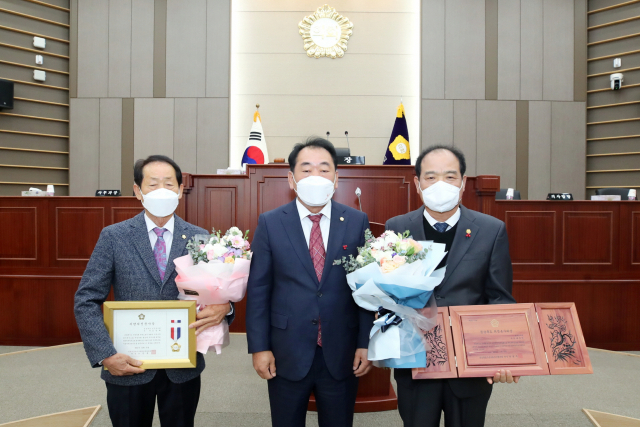 김영래(왼쪽)·배재만(오른쪽) 성주군의원이 각각 지방의정봉사상과 의정봉사대상을 수상하고 김경호 의장과 기념사진을 찍고 있다. 성주군의회 제공