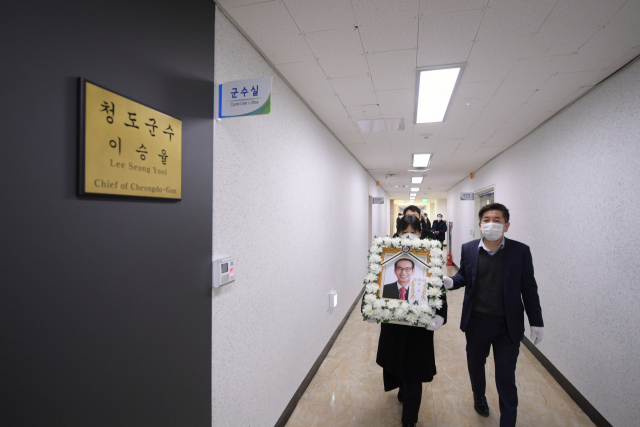 6일 오전 고 이승율 군수의 발인제가 끝난 후 유족들의 손에 들린 고인의 영정이 군수실로 향하고 있다. 청도군 제공