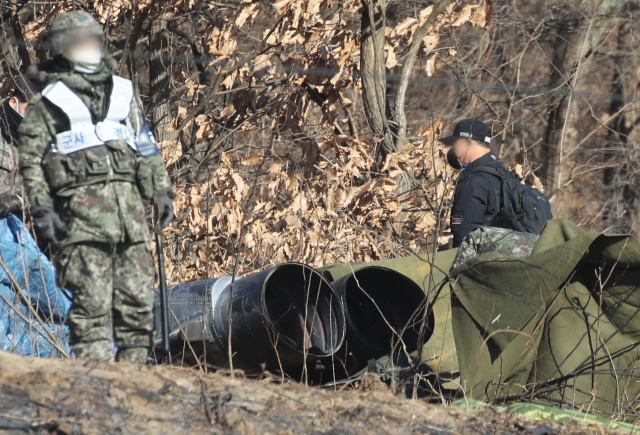 전날 공군 F-5E 전투기 한 대가 추락해 조종사가 순직한 경기도 화성시의 한 야산에서 12일 오전 군 관계자들이 추락 동체 등 현장을 살펴보고 있다. 연합뉴스