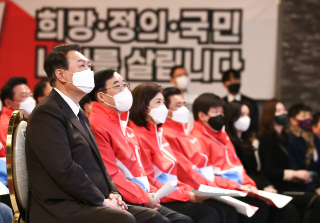 국민의힘 윤석열 대선 후보가 16일 서울 마포구 케이터틀에서 열린 국민의힘 서울 선대위 출범식에서 홍보 동영상을 시청하고 있다. 연합뉴스