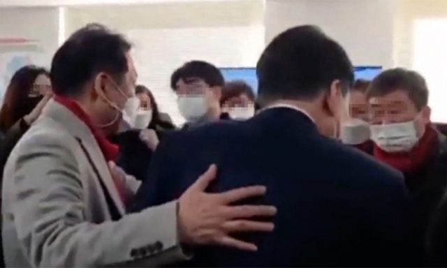 지난 1일 서울 여의도 대하빌딩 9층의 국민의힘 선거대책본부 하부 조직 네트워크본부 사무실에서 무속인 전모 씨(왼쪽)가 윤석열 대선 후보를 이끌며 관계자들과 인사하거나 사진을 촬영하도록 안내하고 있다. 유튜브 갈무리