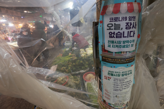 19일 서울 동대문구 경동시장에 코로나19 방역 안내문이 부착돼 있다. 이날부터 소기업·소상공인을 위한 코로나19 손실보상금 선지급 신청이 시작됐다. 신청 대상은 지난해 12월 6일부터 영업시간 제한 조치를 받은 소기업·소상공인 55만명이다. 신청자는 지난해 4분기와 올해 1분기 손실보상금으로 250만원씩 총 500만원을 선지급 받는다. 신청 첫 5일간은 대표자의 주민등록번호 출생연도 끝자리를 기준으로 