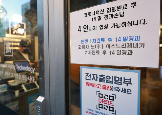 14일 오후 저녁 장사를 앞둔 서울 종로구의 한 식당 입구에 방역패스(백신접종증명·음성확인제) 관련 안내문이 부착돼 있다. 서울행정법원 행정4부는 이날 조두형 영남대 의대 교수와 의료계 인사들, 종교인 등 1천23명이 서울시장을 상대로 낸 집행정지(효력정지) 신청을 일부 인용했다. 이 결정으로 서울 내의 방역패스를 3천㎡ 이상 상점·마트·백화점에 적용한 조치의 효력이 정지된다. 아울러 12∼18세 청소년에 대해서는 17종의 시설 전부에서 방역패스의 효력이 정지된다 법원은 마트, 백화점 등은 필수 이용 시설로 출입 통제는 과도한 제한이라고 판단했다. 반면 식당, 카페 등의 방역패스는 현행 유지된다. 연합뉴스
