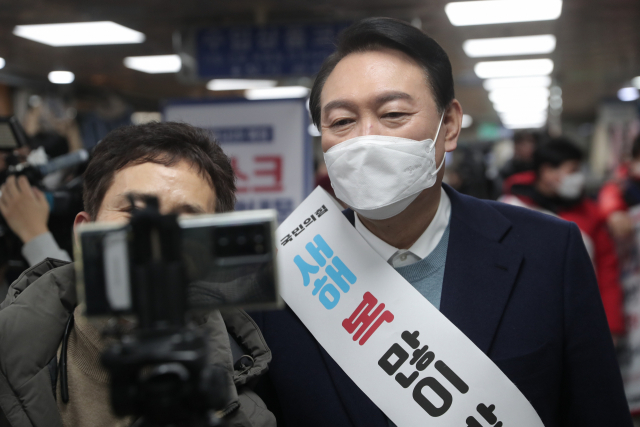국민의힘 윤석열 대선 후보가 31일 안양역을 찾아 시민들에게 새해 인사를 하며 기념촬영을 하고 있다. 연합뉴스
