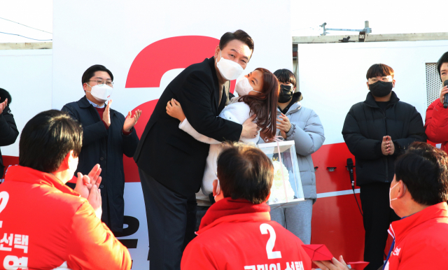 국민의힘 윤석열 대선 후보가 칠곡군 왜관초등학교 유아진(6학년) 학생과 포옹하고 있다. 유아진 학생은 6·25전쟁 낙동강방어선 전투에서 실종된 미 육군 중위 제임스 엘리엇(James Elliot)의 유해를 찾아달라며 지난해 7월 백선기 칠곡군수에게 손편지를 보냈고, 이날 윤 후보에게도 같은 주문을 했다. 이현주 기자