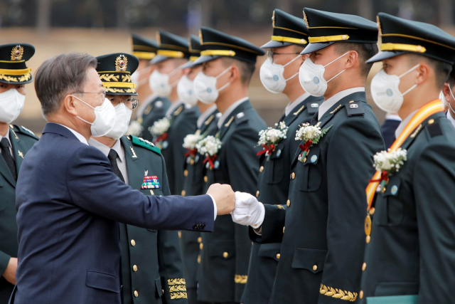 28일 경북 영천에서 열린 육군3사관학교 제57기 졸업 및 임관식에서 문재인 대통령이 신임 장교와 주먹 인사를 나누며 임관을 축하하고 있다. 육군3사관학교 제공
