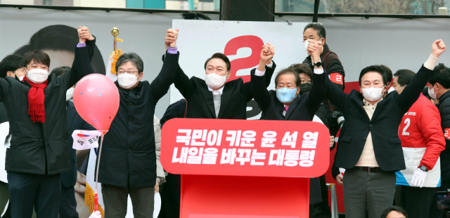 국민의힘 윤석열 대선 후보가 1일 오후 서울 서대문구 현대백화점 신촌점 유플렉스 앞에서 열린 유세에서 이준석 대표, 유승민, 홍준표, 원희룡 대선 경선후보들과 손을 들어 환호에 답례하고 있다. 연합뉴스