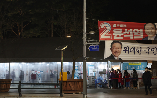 제20대 대통령선거를 하루 앞둔 8일 오후 독립문 광장에 마련된 코로나19 선별검사소에 시민들이 PCR 검사를 받기 위해 줄을 서서 기다리고 있다. 서울시 등 각 지방자치단체에 따르면 이날 0시부터 오후 6시까지 전국 17개 시도에서 코로나19 확진 판정을 받은 사람은 26만3천523명으로 집계됐다. 전날 같은 시간대 집계치인 17만6천86명보다 8만7천437명 많다. 연합뉴스