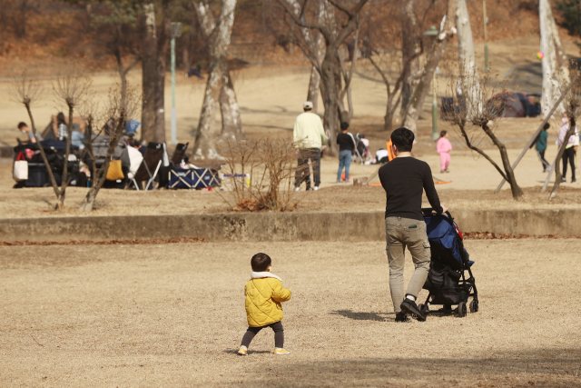 서울 낮 최고기온이 15도까지 오르는 등 포근한 봄 날씨를 보인 9일 오후 서울 광진구 어린이대공원을 찾은 아빠와 아들이 산책을 하고 있다. 연합뉴스