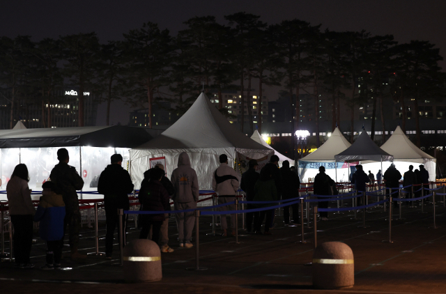 11일 오후 서울 마포구 월드컵공원에 마련된 코로나19 임시 선별검사소에서 시민들이 검사를 받기 위해 줄을 서고 있다. 이날 0시부터 오후 6시까지 전국 17개 시도에서 코로나19 확진 판정을 받은 사람은 29만8천666명으로 집계됐다. 오후 6시 집계 기준으로 역대 가장 많은 확진자다. 연합뉴스