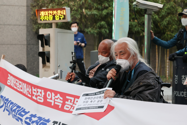 박경석 전국장애인차별철폐연대(전장연) 공동대표가 23일 오후 서울 강남구 레미안 도곡카운티 아파트 단지 입구에서 추경호 경제부총리 겸 기획재정부 장관 후보자에게 장애인 권리예산 보장 약속 공문 전달을 하기 앞서 기자회견을 하고 있다. 연합뉴스