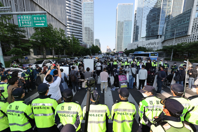 전국장애인차별철폐연대(전장연) 회원들이 오는 20일까지 서울 용산구 일대에서 장애인 권리 예산 보장 등을 요구하는 시위를 이어간다. 사진은 지난 16일 오전 서울 신용산역에서 대통령실로 향하는 한강대로의 횡단보도에서 5개 차로를 점거한 시위 참가자들 모습. 연합뉴스
