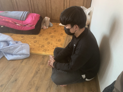 이현우(가명·23)씨가 엄머니가 없는 텅 빈 방안에 홀로 앉아있다. 김세연 기자