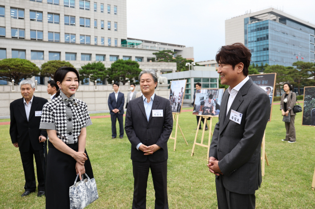 김건희 여사가 12일 오후 서울 용산 대통령실 청사 잔디마당에서 열린 영화관계자 초청 만찬에서 한국 배우 최초로 칸국제영화제에서 남우주연상을 받은 배우 송강호(영화 브로커)와 감독상을 수상한 박찬욱 감독(영화 헤어질 결심)과 대화하고 있다. 연합뉴스